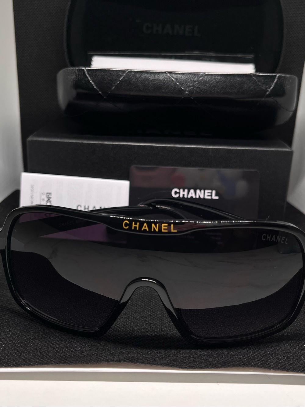 CHANEL Black Shield Sunglasses with Gold Logo Accent
